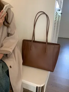 Minimalist brown vintage large capacity tote bag for women in a lifestyle setting