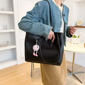 Large black vintage tote bag shown as a lifestyle shoulder bag for daily commuting