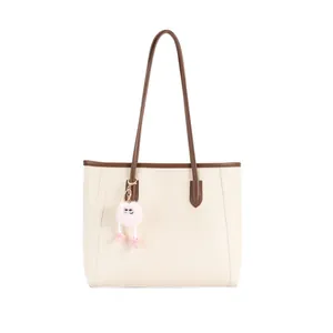 Large capacity vintage cream tote bag featuring brown straps and a cute pink fluffy charm