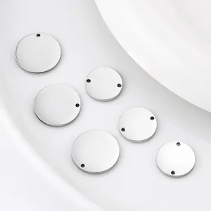 Detailed view of mirror polished stainless steel round tags with holes for DIY jewelry.