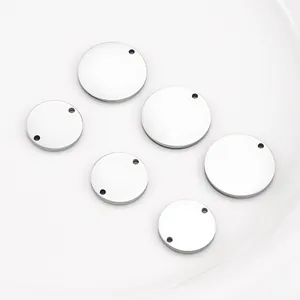 Macro view of mirror polished round stainless steel blank tags for DIY jewelry making