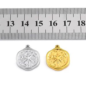Close-up view of hammered eight-pointed star stainless steel charms with ruler for size scale