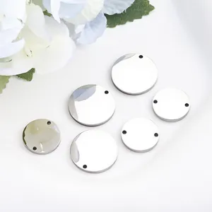 Detailed view of mirror polished round stainless steel blanks for DIY jewelry making.