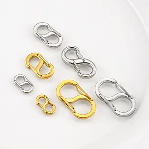 Detailed view of polished S-shaped stainless steel carabiners in gold and silver colors