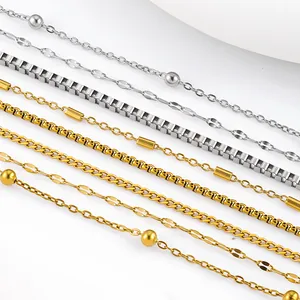 Close-up macro detail of various titanium steel chains in gold and silver metal finishes