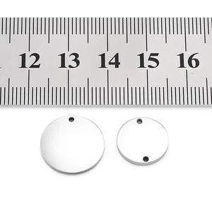 Mirror polished stainless steel round pendants shown with ruler for size reference