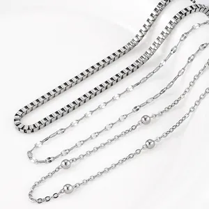 Close-up of three titanium steel necklace chain styles in polished silver finish