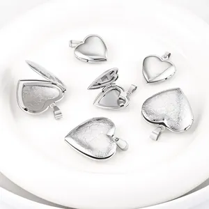 Detailed view of polished stainless steel heart locket pendants with floral engravings.