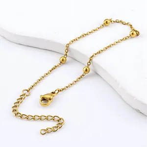 Close-up of gold stainless steel bead bracelet with extender chain and lobster clasp