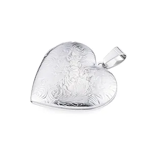 Polished stainless steel heart locket pendant with intricate floral engravings.