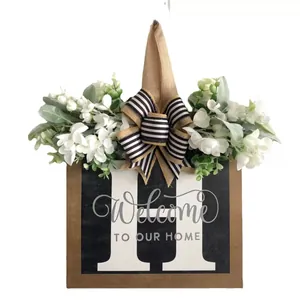 Rustic wooden front door hanging sign featuring letter H and floral welcome message