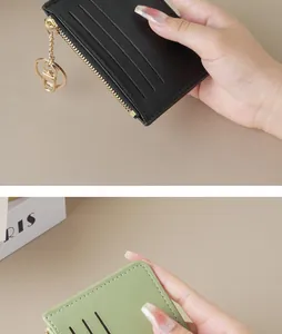 Close-up of slim multi-slot card wallet with zipper and keychain in hand