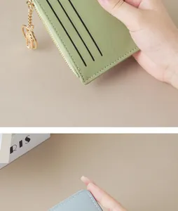 Close-up of slim women's card holder wallet with zipper and keychain