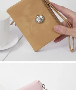 Detail shot of women's ochre wristlet wallet with elegant gemstone buckle embellishment
