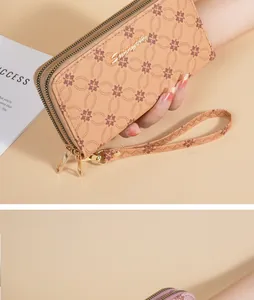 Detailed view of khaki soft leather women's long wallet with double zipper and floral pattern