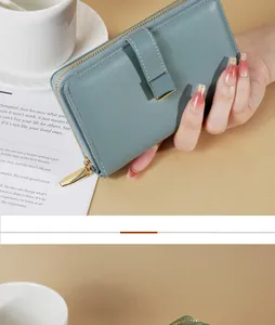 Vista dettagliata del portafoglio da donna verde teal con hardware dorato e fessure