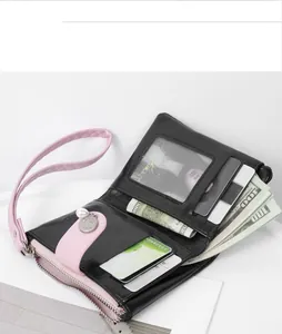 Internal view of black cracked leather wallet with pink wristlet and pearl charm