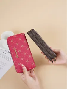 Elegant women's long soft leather wallet with double zipper shown in pink and brown floral