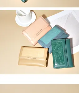 Groep drievoudige portefeuilles met krokodillenpatroon in roze, blauw, beige en groen