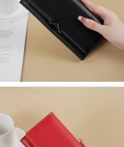 Close-up of stylish black and red PU leather long wallets with V-shaped metal accents