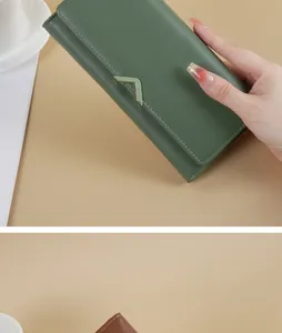 Close-up of a stylish dark green PU leather long wallet featuring a V-shaped metal clasp
