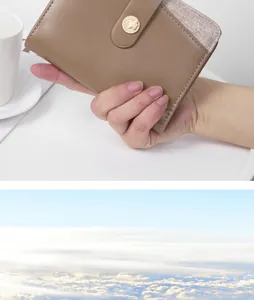 Close-up of a hand holding a brown leather multi-functional travel passport wallet