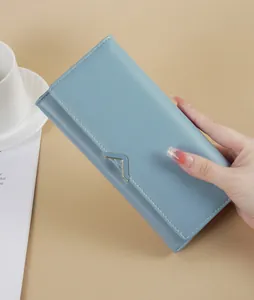 Detailed view of a light blue long PU leather wallet for women with elegant metallic V-shaped clasp