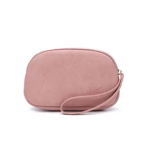 Elegant pink faux leather clutch bag with double zipper and a practical wristlet strap.