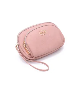 Small pink faux leather wristlet wallet with double zipper and gold PRETTYZYS logo