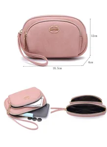 Detail view of pink double zipper clutch bag showing dimensions and interior capacity