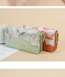 Detailed view of floral embroidered long wallets with double zippers and patchwork design