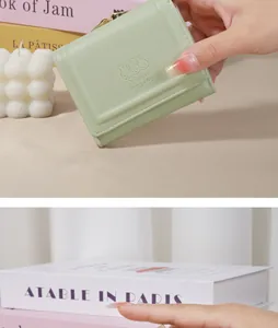 Close-up of the cute embossed bunny detail on a light green PU leather small wallet