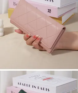 Close-up of an elegant pink quilted long wallet for women with diamond stitch pattern