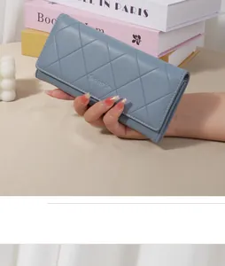 Macro view of blue quilted long wallet featuring elegant diamond pattern stitching detail