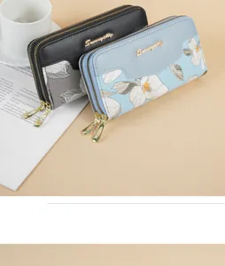 Detailed view of elegant black and light blue long wallets with floral embroidery