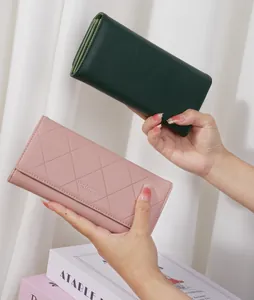 Close-up of pink and green quilted long wallets for women with elegant diamond pattern