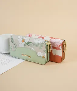 Detail view of the intricate Chinese style floral embroidery on a long women's clutch wallet.