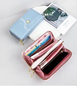 Detailed view of women's double zipper long wallet showing large internal capacity