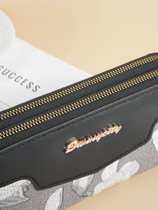 Close-up of black and floral embroidery long wallet with dual gold zippers for women