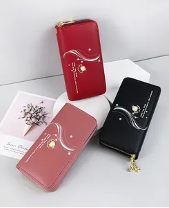 Three elegant pearl-accented long wallets with double zippers in red, pink, and black colors.