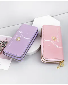 Detail of elegant pearl double zipper long wallets in purple and pink pastels.
