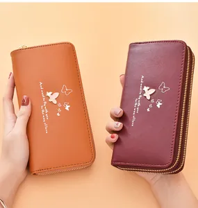 Close-up of double-zipper long wallets with elegant butterfly design in tan and red