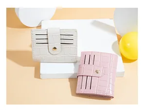 Macro view of women's short crocodile pattern card wallets in pink and white colors