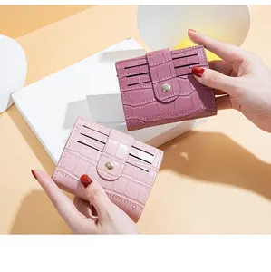 Close-up of pink crocodile pattern card holder wallets with multiple card slots