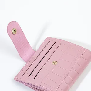 Compact pink faux crocodile skin small wallet with card slots and snap button closure