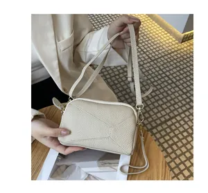 Detailed shot of a stylish beige pebbled leather small crossbody phone bag for women