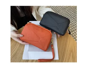 Genuine leather phone bags in orange and black with geometric stitching detail.