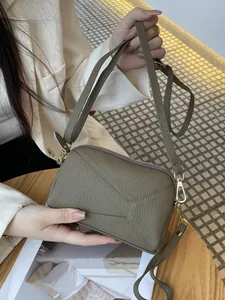 Genuine leather small crossbody phone bag with textured finish and geometric stitching