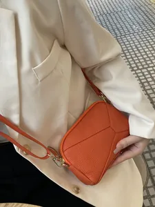 Vibrant orange genuine leather phone bag for women with elegant geometric stitching detail