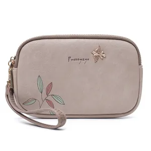 Macro view of grey minimalist women's clutch bag with Prettyzys logo and leaf print detail